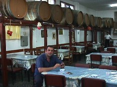 The famous Adonis Boulis in his taverna in Sifnos with barrels of his excellent wine
