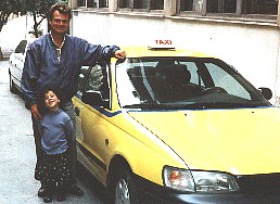 George and his old taxi in Athens, Greece